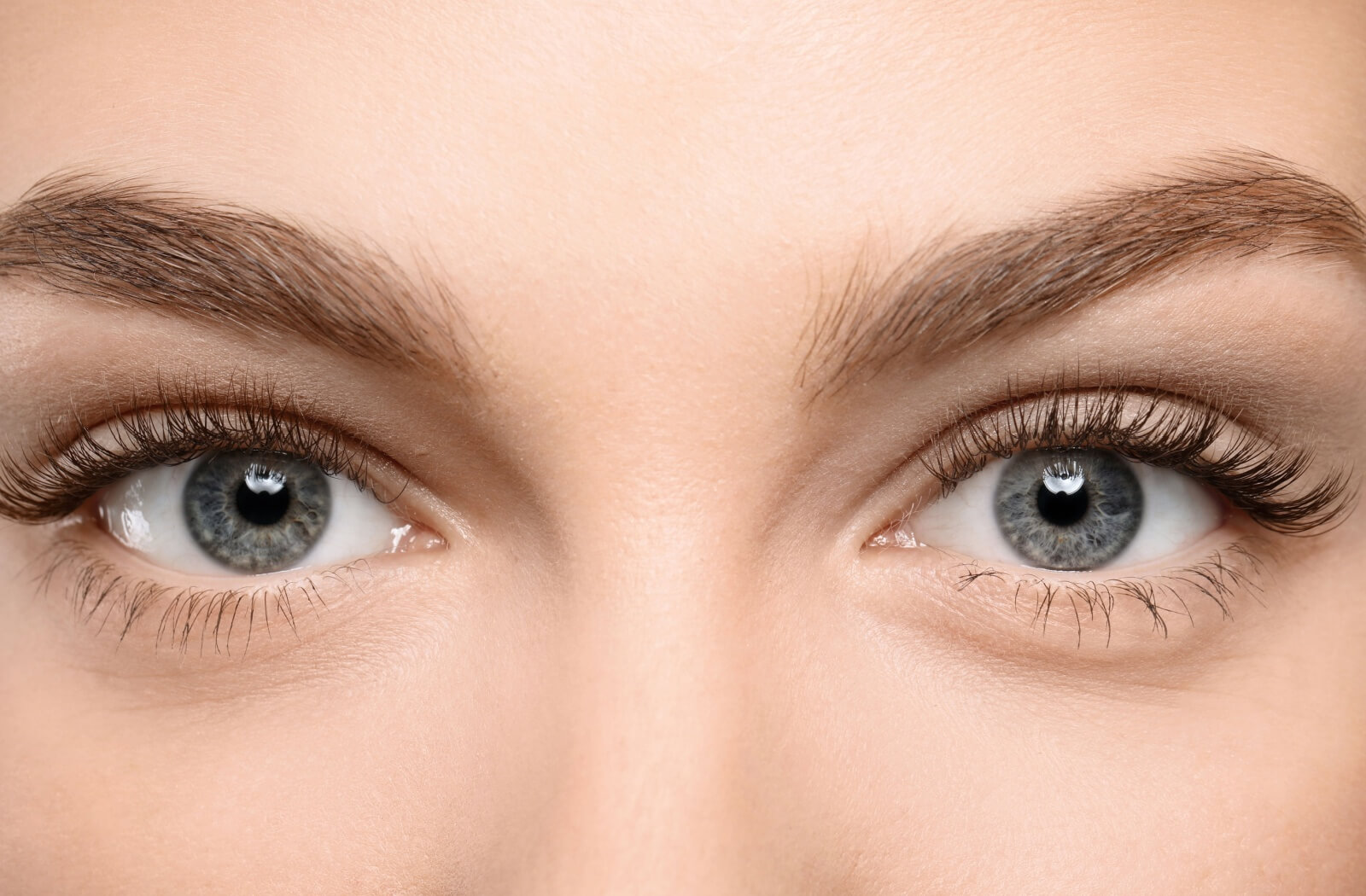 A close-up view of a woman's gray/blue eyes