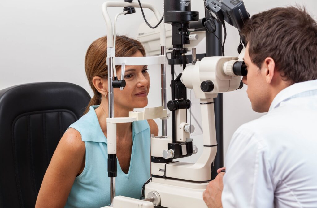 Person undergoing an eye exam using a slit lamp with an optometrist in a clinic setting