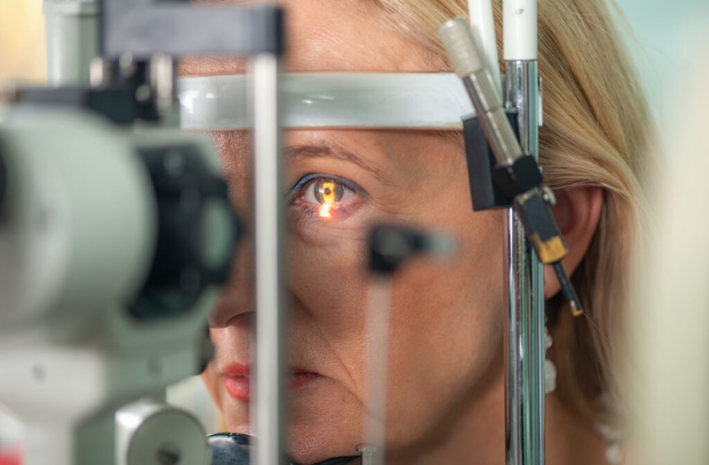 A person getting a slit lamp eye test done during a routine eye exam