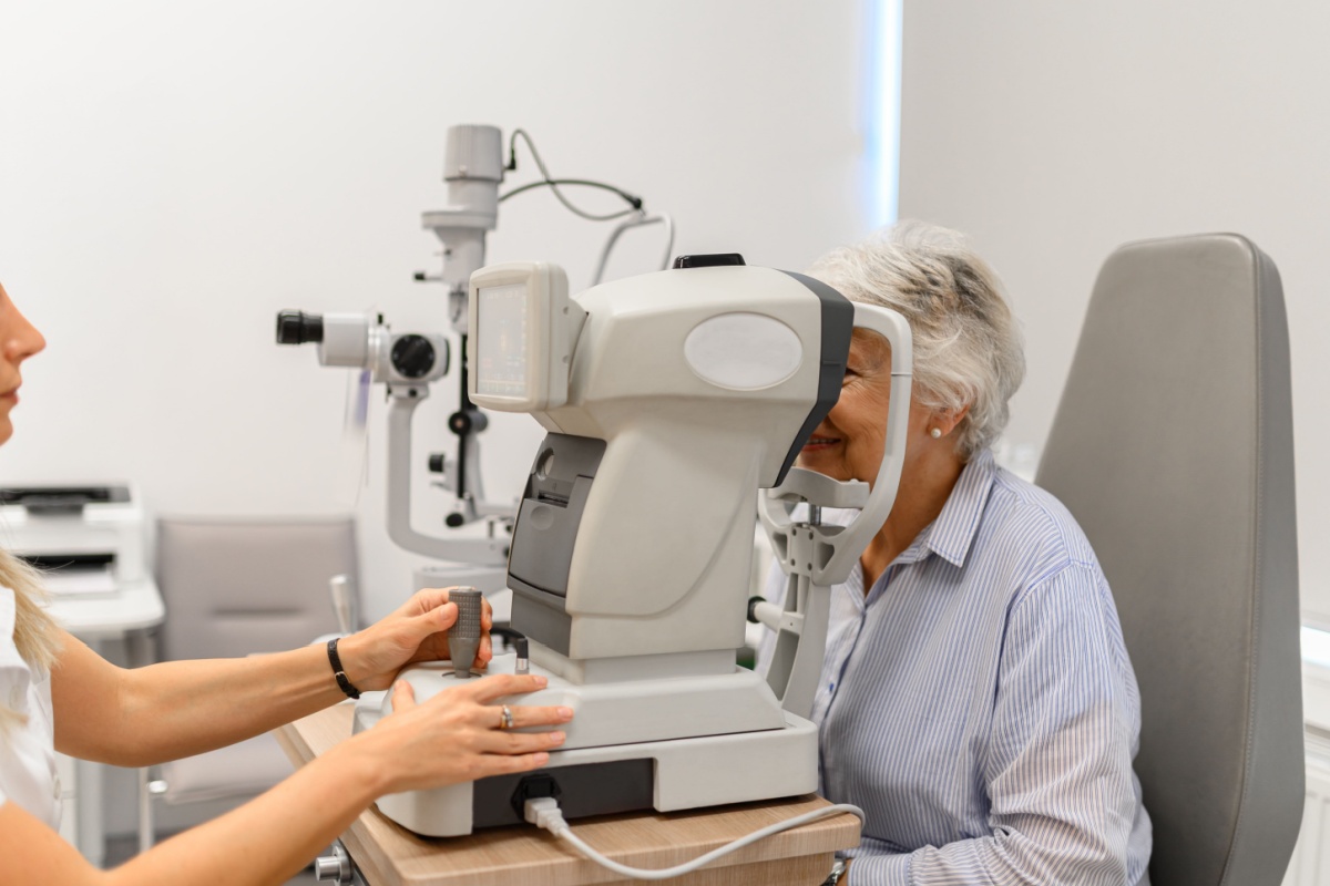 A senior person getting an eye test done during a routine eye exam